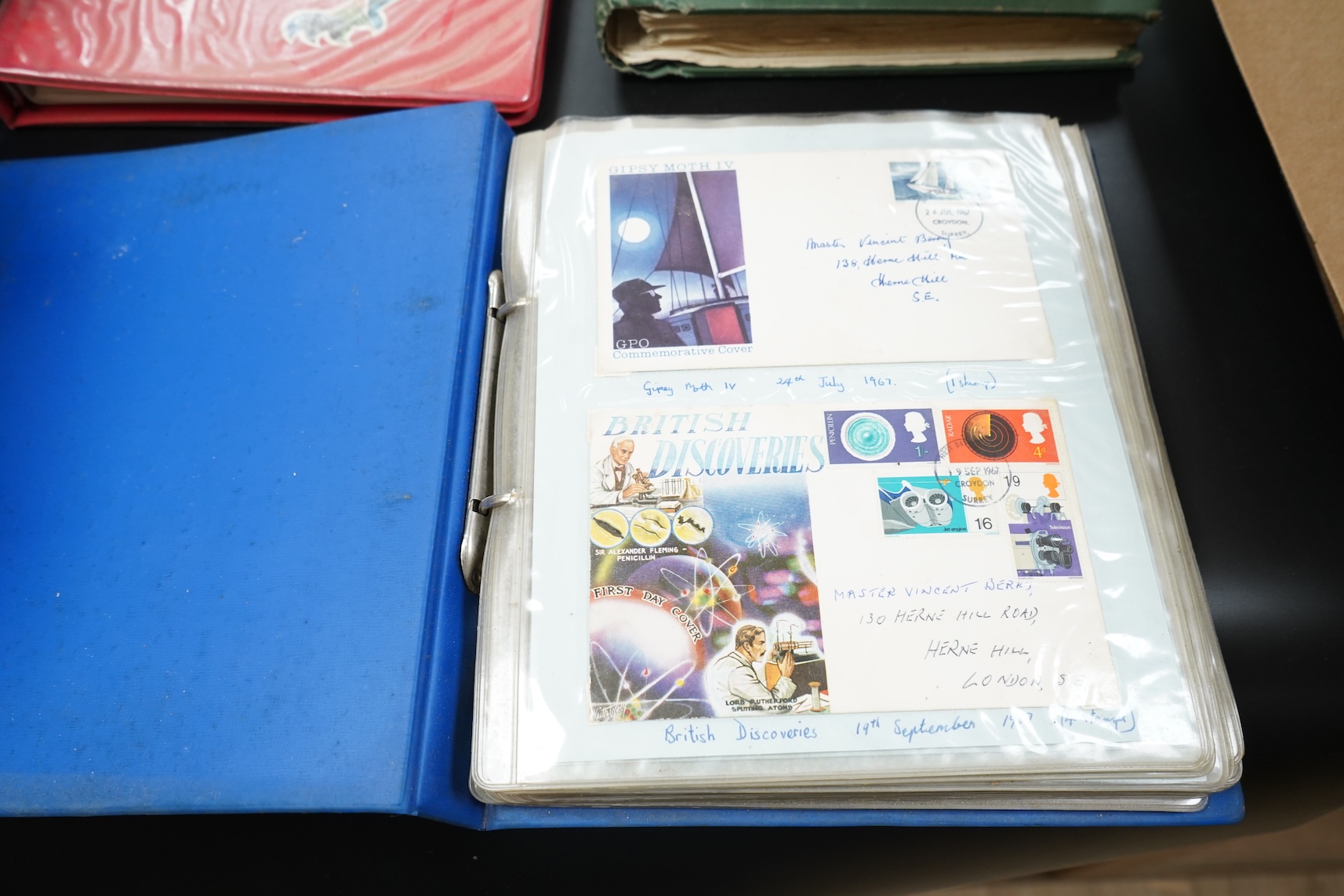 Four stamp albums including a first day cover album